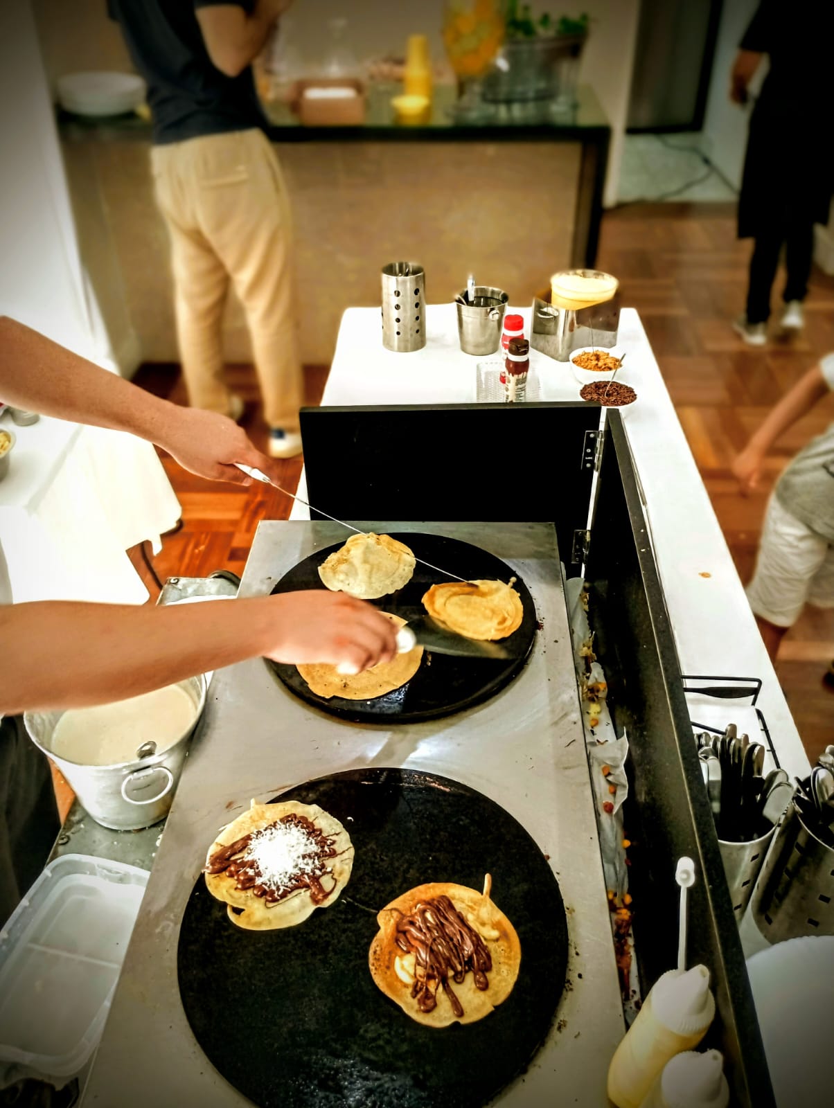 Profissional preparando crepe em uma estação ao vivo